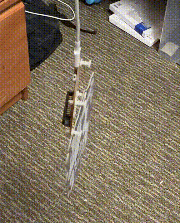 A badge bouncing while hanging from a USB-C cable during a shake test