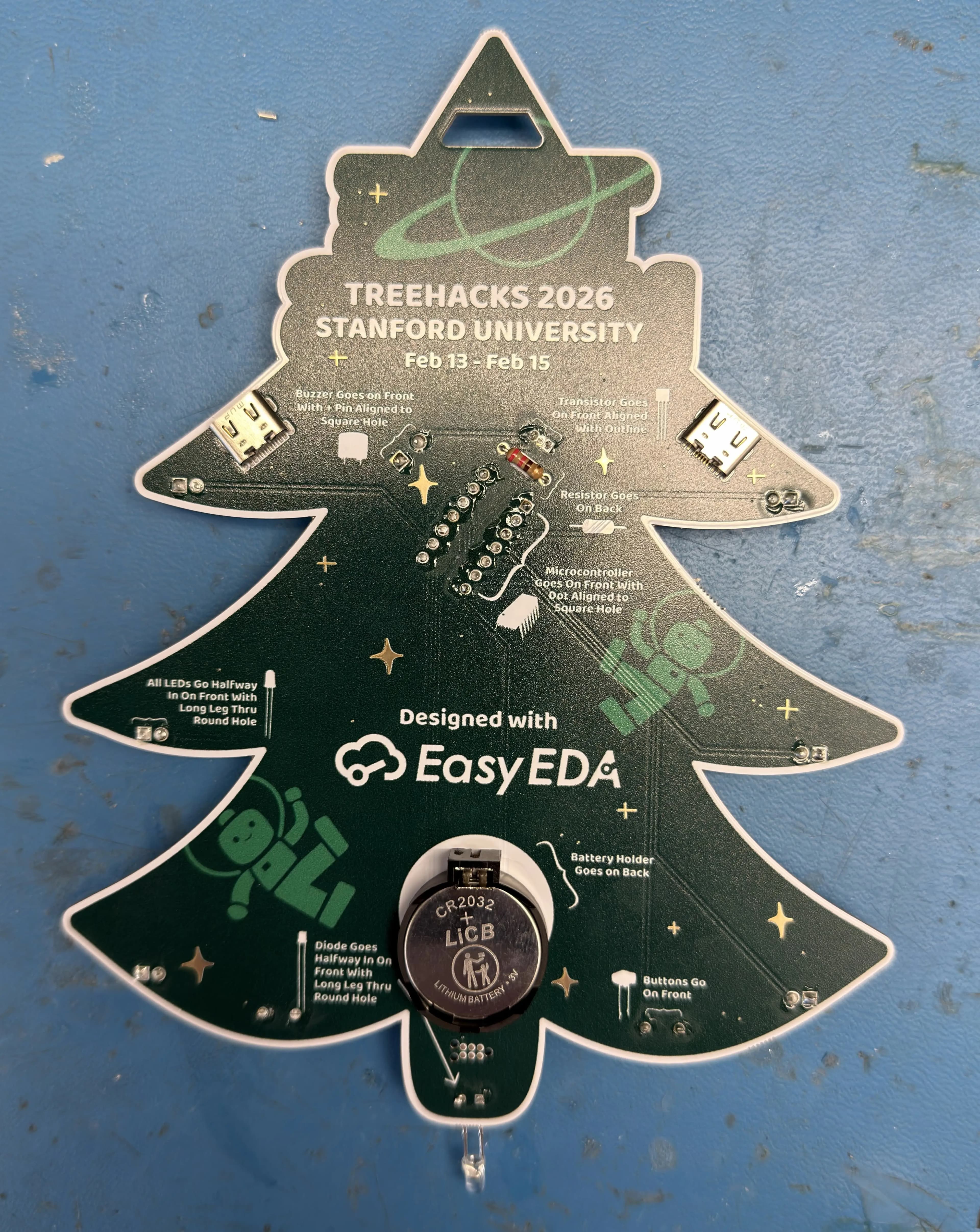Back of a finished badge showing the battery holder, buzzer, and assembly instructions