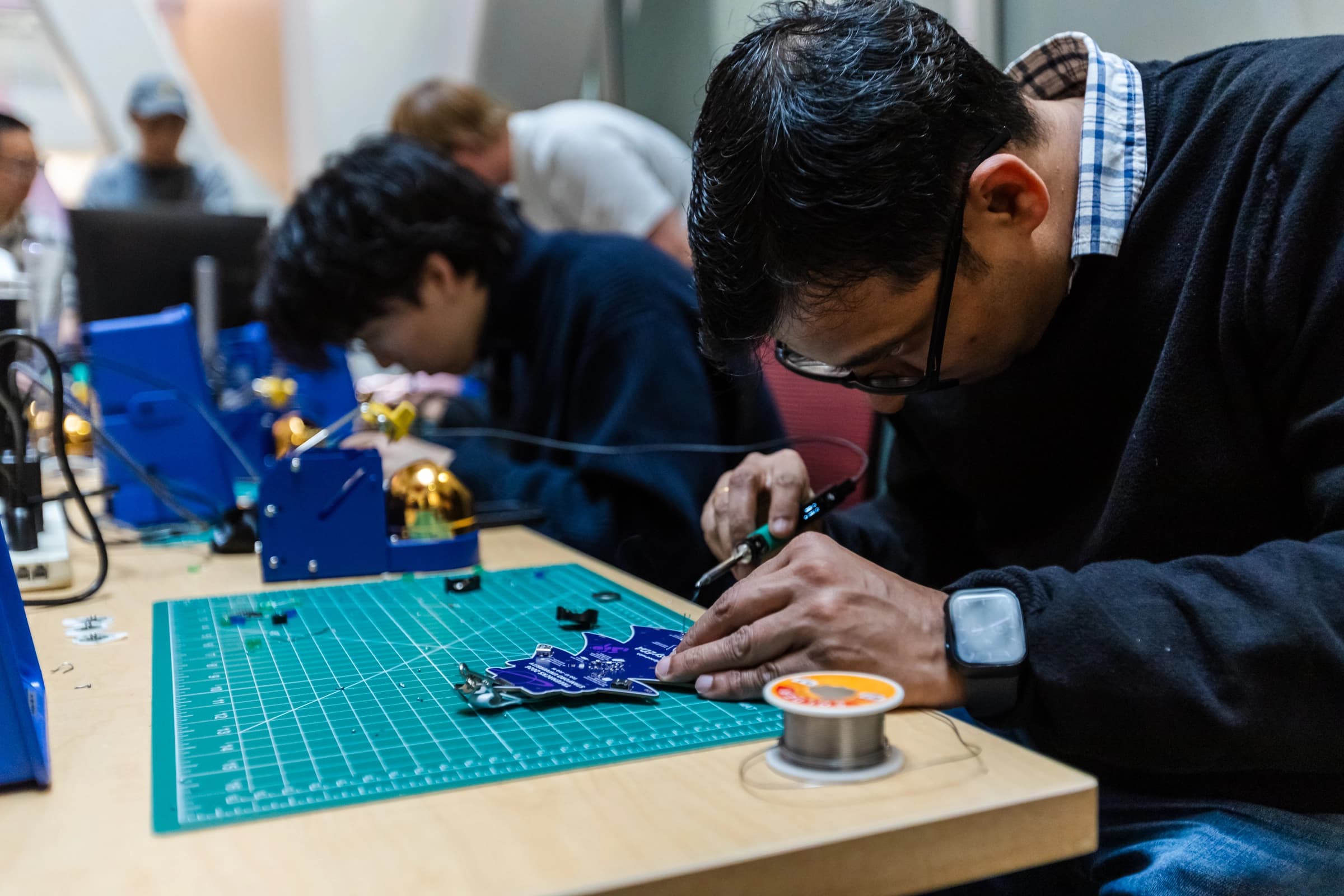 A badge being soldered