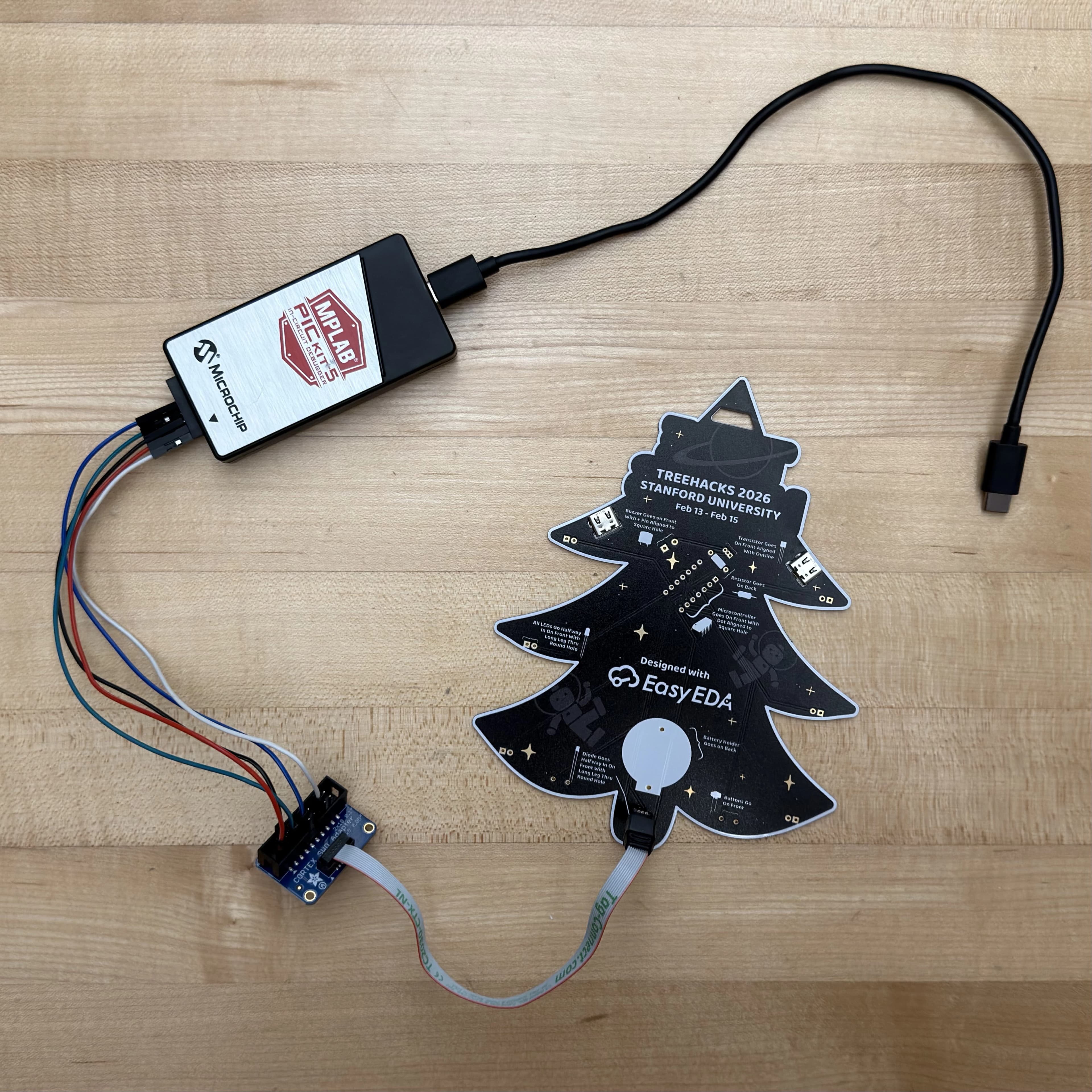 Tag-Connect debug header pads on the back of a badge